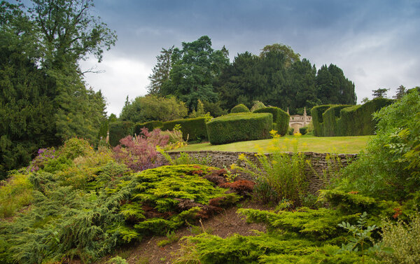 CHIPPENHAM, UK - AUGUST 9, 2014: Castle Combe, luxury house and gardens turned to be a hotel and golf club