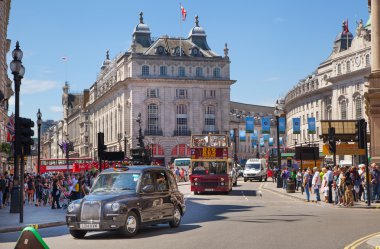 LONDON, UK - SEPTEMBER 30, 2014: People and traffic in Piccadilly Circus in London. Famous place for romantic dates.Square was built in 1819 to join of Regent Street clipart