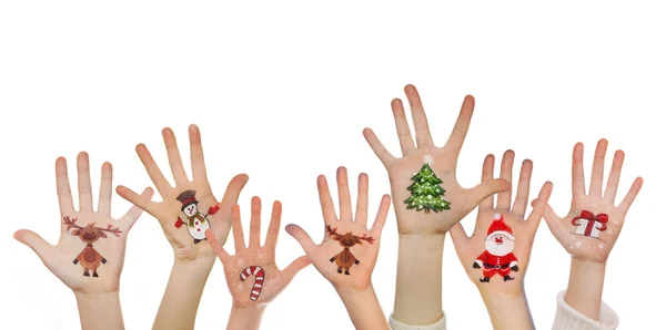Παιδικά χέρια υψώνοντας με ζωγραφισμένα σύμβολα Χριστούγεννα: Άγιος Βασίλης, χριστουγεννιάτικο δέντρο, άνθρωπος χιόνι, βροχή ελάφια, παρόν πλαίσιο — Φωτογραφία Αρχείου