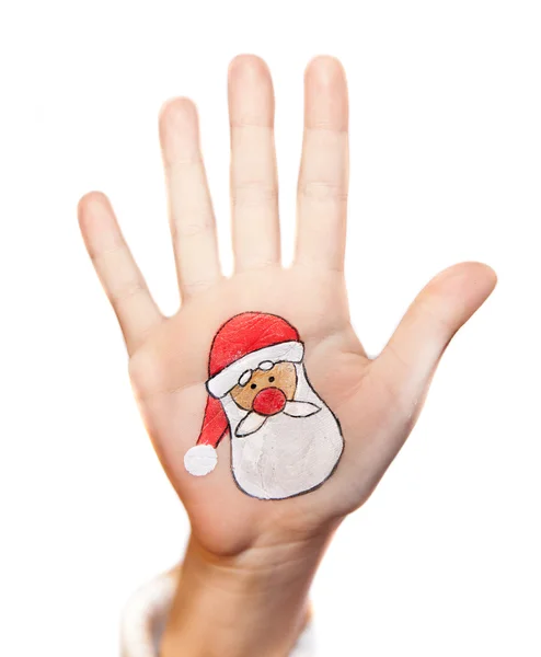 Children's hands raising up with painted Christmas symbols: Santa Claus, Christmas tree, Snow man, rain deer, present box — Stock Photo, Image