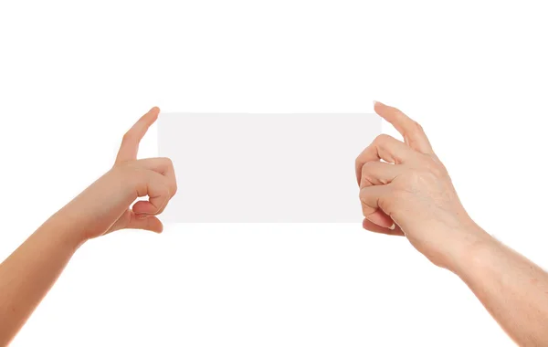 Adult's  hand and child's hand holding white paper, cardboard. White background with space for text — Stock Photo, Image