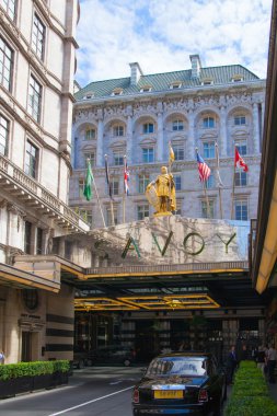 LONDON, UK - 22 JULY, 2014: Savoy hotel, one of the best holes in London and Europe. Main entrance and taxi averting the client clipart