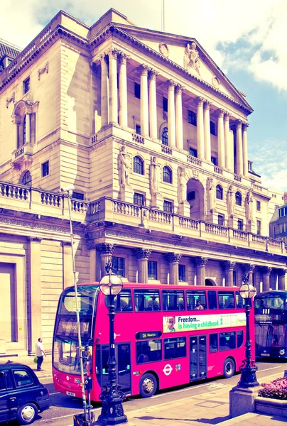 LONDON, UK - JUNE 30, 2014: Bank of England. Square and underground station with red bus on foreground — Stok fotoğraf