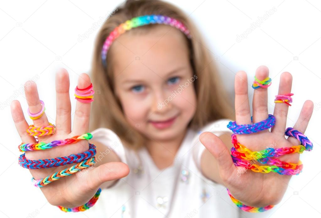 Loom bands craft. Little girl demonstrating her works.