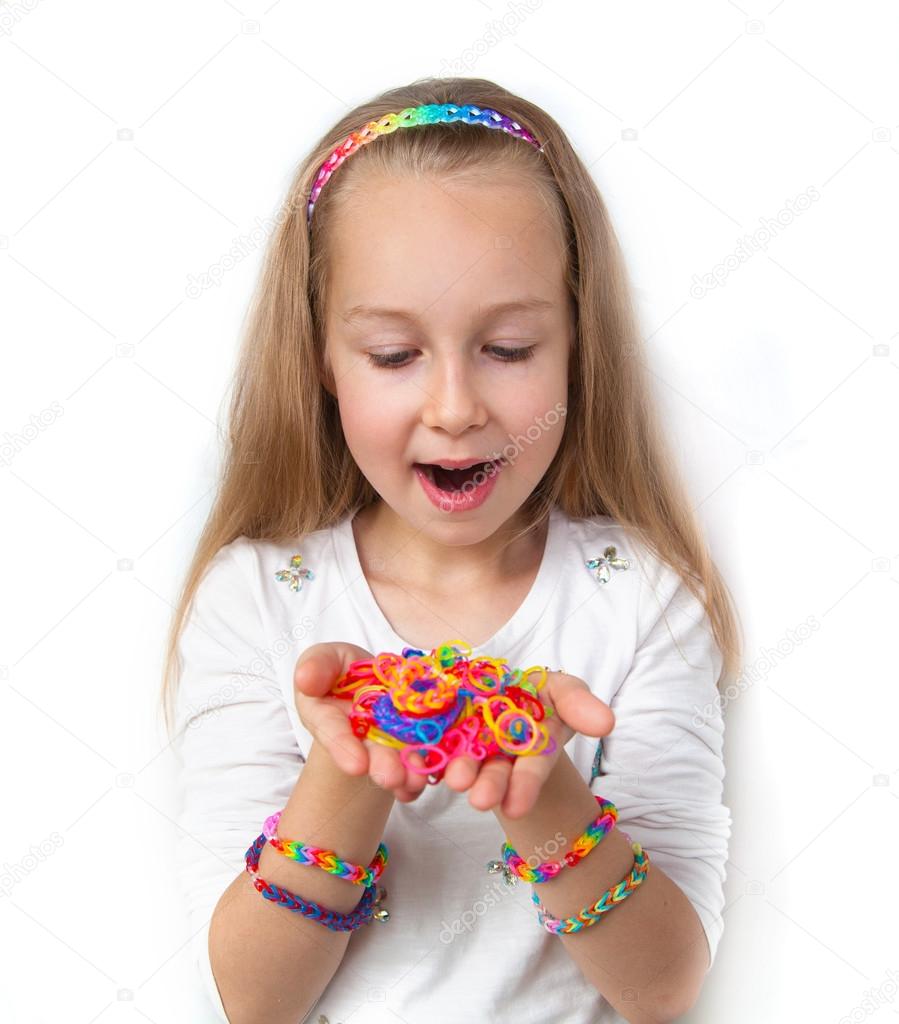 Loom bands craft. Little girl demonstrating her works.