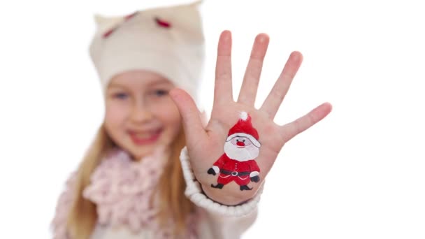 Happy girl demonstrating painted Christmas symbols on her hands. Santa and reindeer — Stock Video