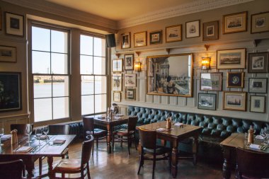 LONDON, UK - APRIL 14, 2015: Old English victorian public house interior. Early morning settings with no people