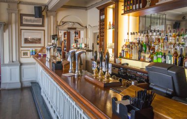 LONDON, UK - APRIL 14, 2015: Old English victorian public house interior. Early morning settings with no people