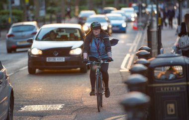 LONDON, UK - 7 SEPTEMBER, 2015: Londoners commuting from work by bike. Road view with cars and cyclers