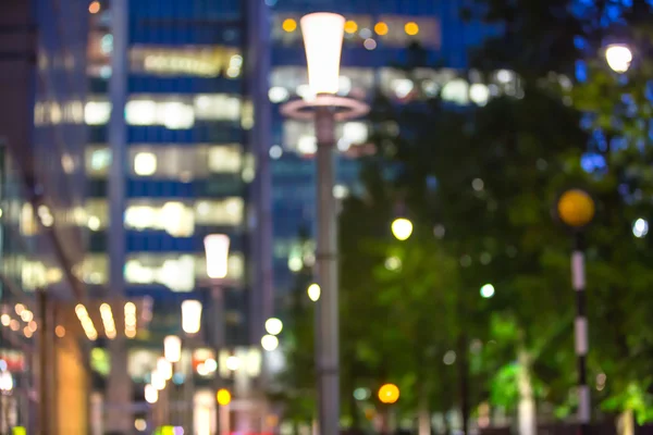 City lights blur background. London, Canary Wharf night life. Traffic, roads, lanterns and lit up office buildings — Stock Photo, Image