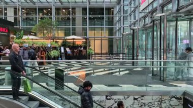 Londra, İngiltere - 7 Ekim 2025: Canary Wharf 'taki modern gökdelenin lobisinden çıkan insanlar