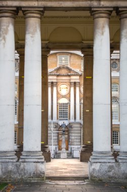 London, Greenwich old offices. Classic English architecture. View includes University of Greenwich building and people walking by