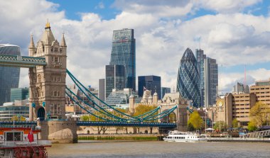 LONDON, UK - APRIL 30, 2015: Tower bridge and City of London financial aria on the background. View includes Gherkin and other buildings clipart