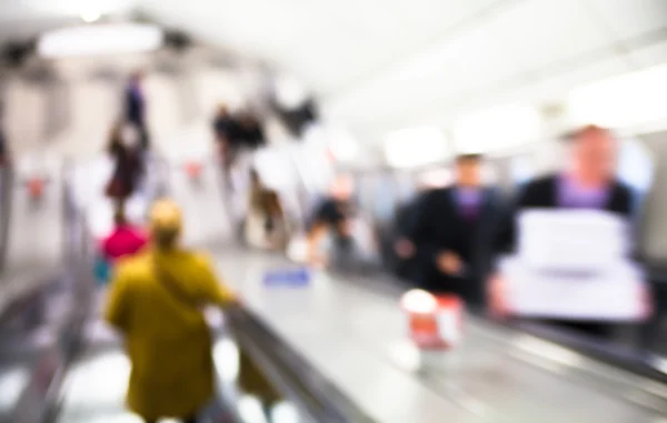 Blur of people going down at escalator, London underground Stock Image