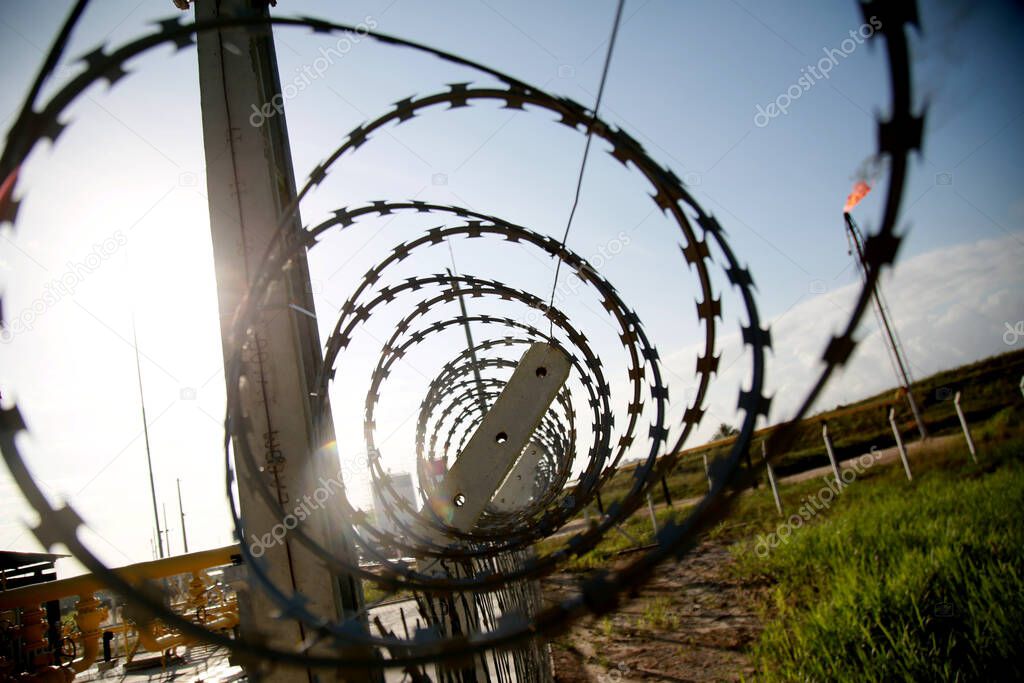 mata de sao joao, bahia / brazil - november 8, 2020: concertina wire fence is seen in an industrial area in the city of Mata de Sao Joao.