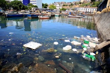 Salvador, Bahia, Brezilya - 11 Aralık 2020: Salvador şehrindeki Feira de Sao Joaquim limanındaki botların yakınında plastik ambalaj ve çöplerin imhası.
