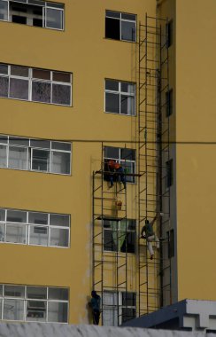 Salvador, Bahia, Brezilya - 22 Ocak 2021: Duvar boyacıları Salvador şehrindeki bir binanın duvarını boyarken görüldü..