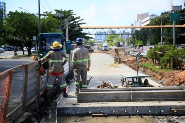 Salvador, Bahia, Brezilya - 26 Mayıs 2021: İnsanlar, Salvador kentindeki Avenida ACM üzerinde özel BRT transit karayolu inşaatında çalışırken görüldü..