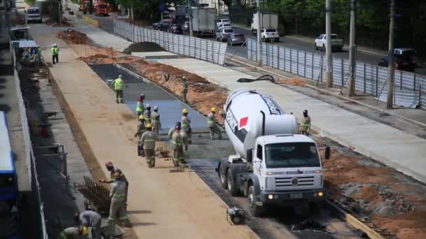 salvador, bahia, brazil - may 26, 2021: concrete mixer truck pours concrete under construction of an exclusive road for BRT in the Itaigara neighborhood in the city of Salvador.