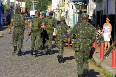 buerarema, bahia, brazil - february 14, 2014: Brazilian Army soldiers are seen while patrolling the streets of downtown Buerarema in southern Bahia.