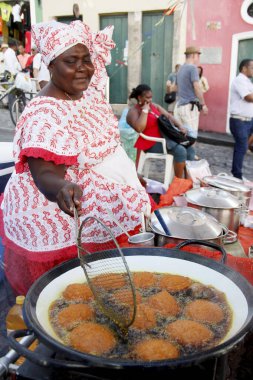 salvador, bahia, brazil - may 9, 2016: baiana prepare acaraj in palm oil frutura in the city of Salvador.