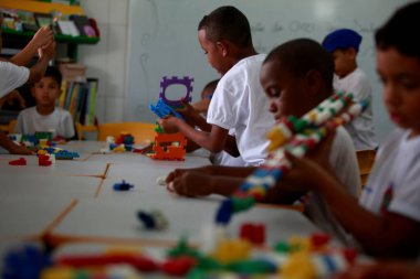 salvador, bahia, brazil - september10, 2015: Children from a public day care center are seen in a classroom in the city of Salvador. clipart