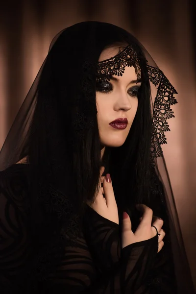 The beautiful girl with black hair in a black veil — Stock Photo, Image