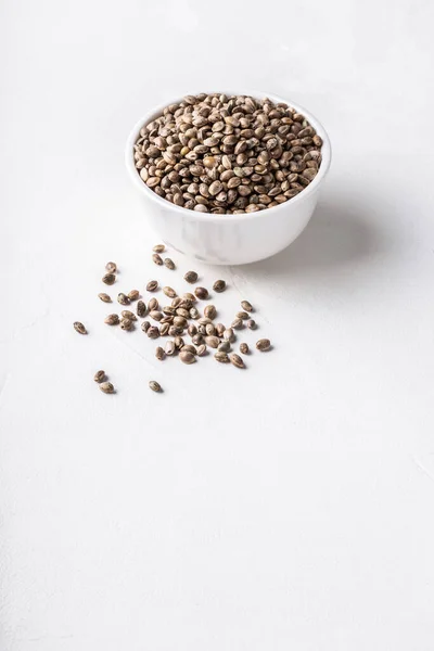Raw Organic Unrefined Hemp Seeds Small White Bowl White Concrete — Stock Photo, Image