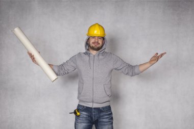 cheerful builder throws up his hands in a gesture of victory