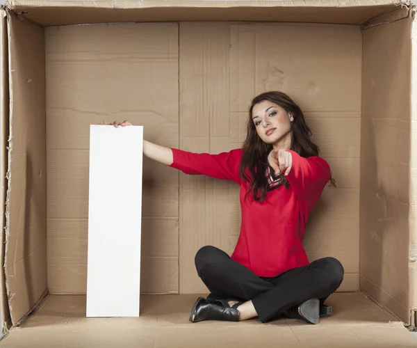 Business woman holds a copy space and pointing at you — 图库照片