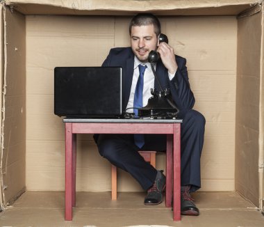 telefon konuşma önde ve bir comp çalışma iş adamı