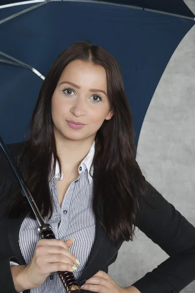 Beautiful business woman under an umbrella — Stock Photo, Image