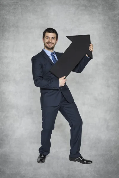 Businessman shows growth — Stock Photo, Image