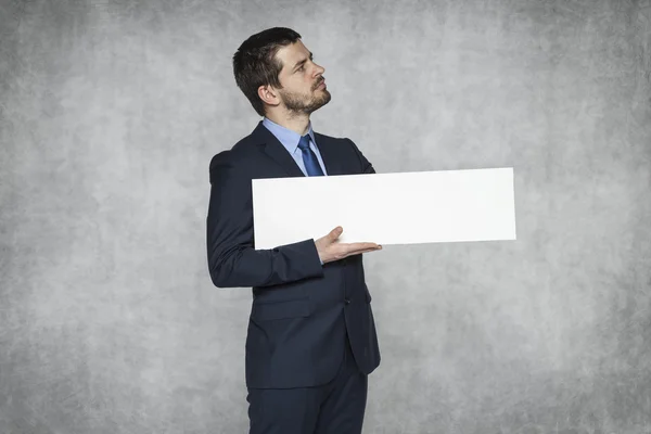 Proud businessman holding advertisement — Stock Photo, Image