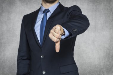 Businessman pointing thumbs down clipart
