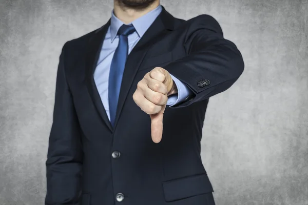 Businessman pointing thumbs down — Stock Photo, Image