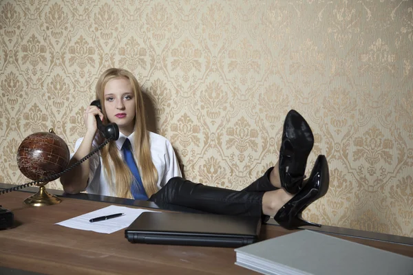 Secretary with her feet on the desk — стоковое фото