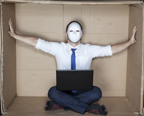 Businessman in a mask displaces office wall — Stock Photo, Image