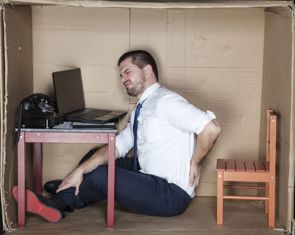 Geschäftsmann saß vor Schmerzen auf dem Boden — Stockfoto