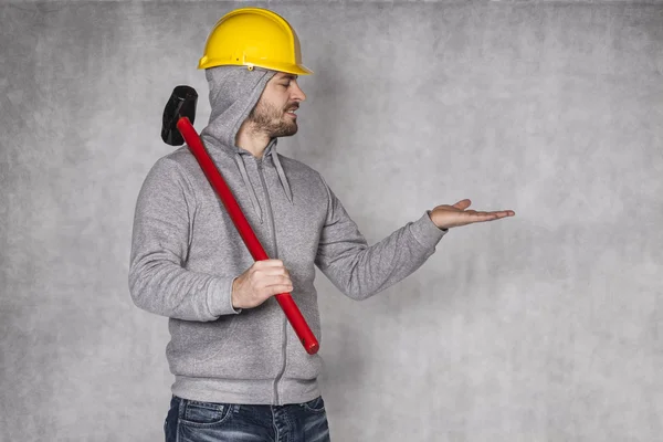 Builder on a grey background, space for advertisement — Stock Photo, Image