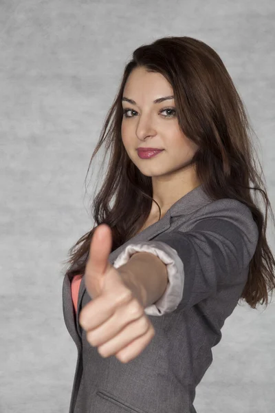 Young businesswoman shows thumb up — Stock Photo, Image