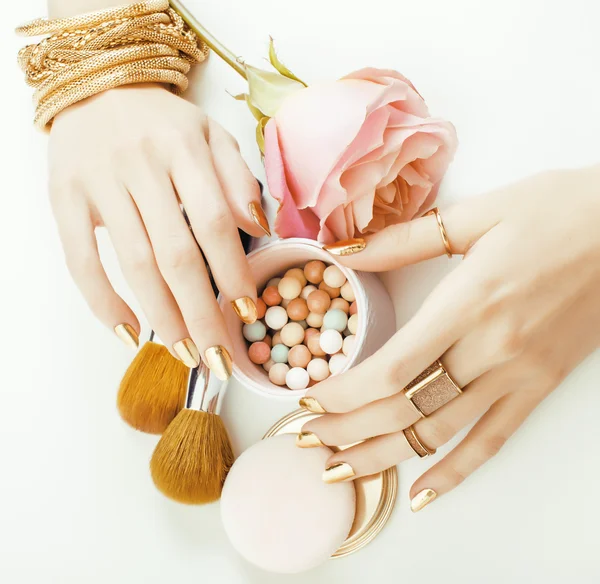 woman hands with golden manicure