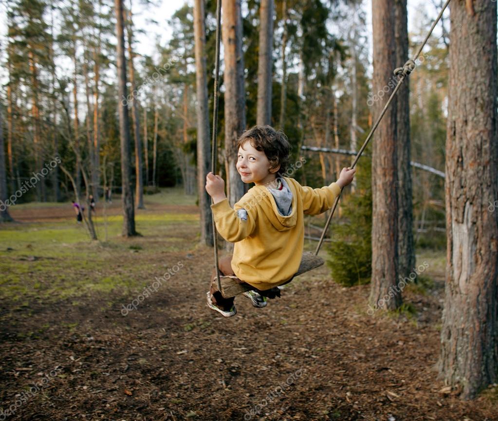 Little Cute Boy Swinging In Wood Lifestyle People Concept