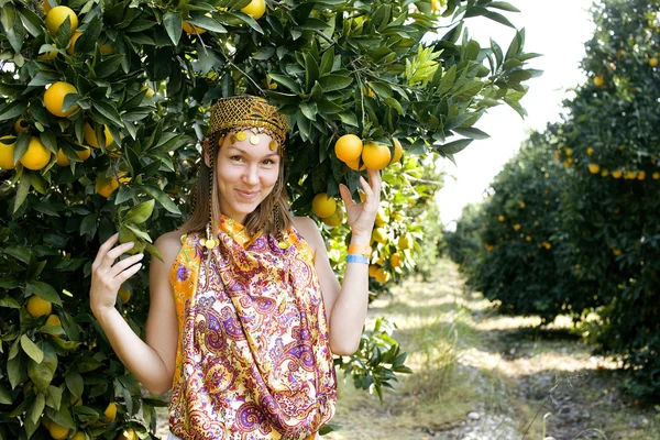 pretty islam woman in orange grove smiling, real muslim girl cheerful