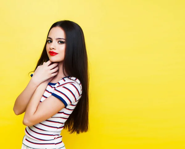 lifestyle people concept: pretty young school teenage girl having fun happy smiling on yellow background