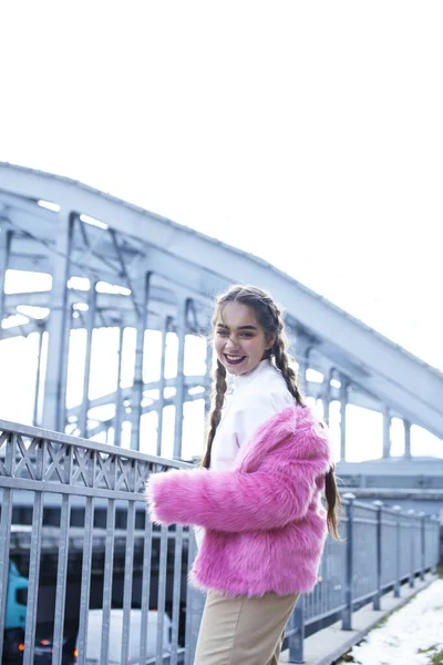 young pretty teenage girl posing cheerful happy smiling wearing street style outside in europe city, lifestyle people concept