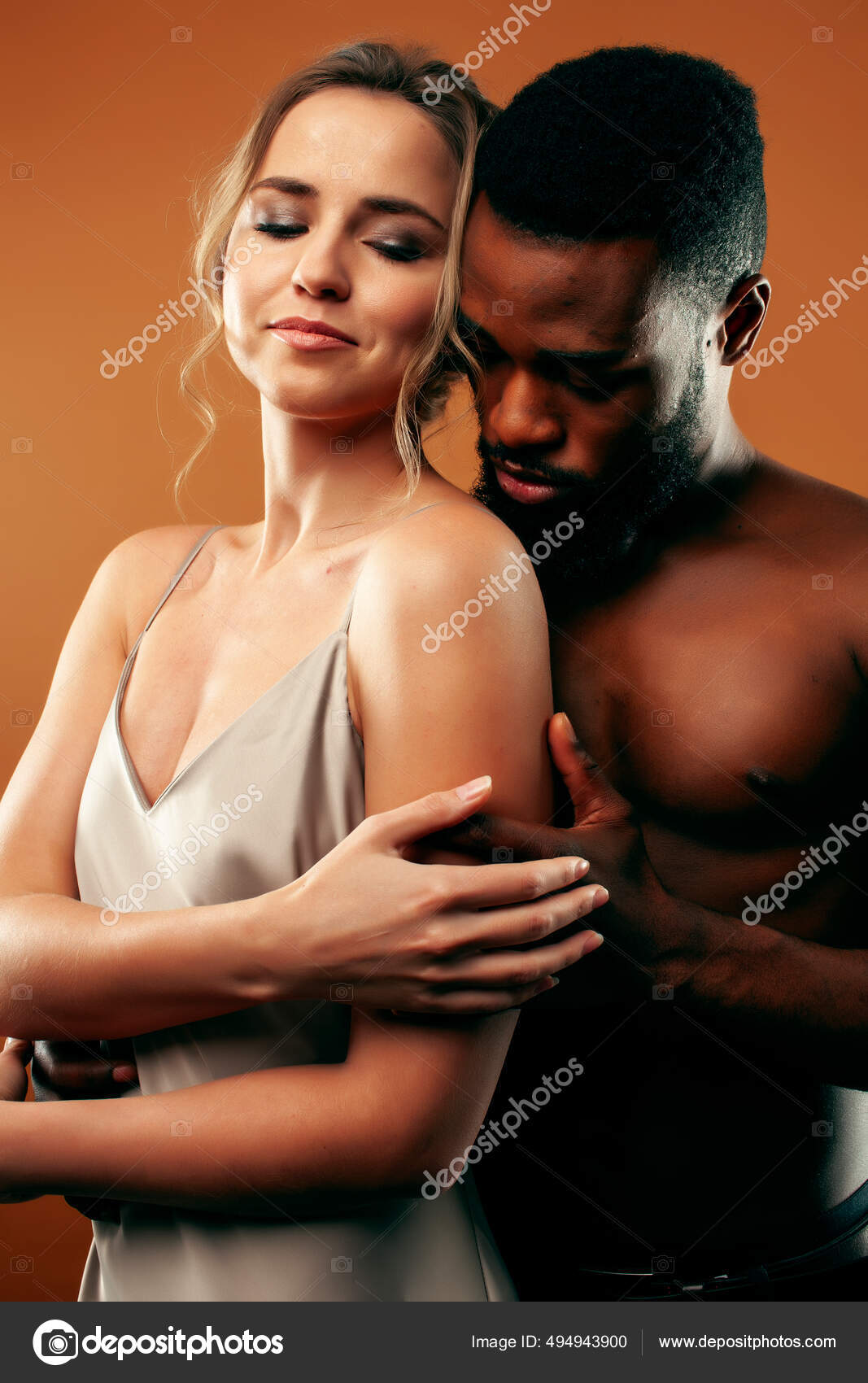 Young pretty couple diverse races together posing sensitive on brown background, lifestyle people concept Stock Photo by ©iordani 494943900 pic
