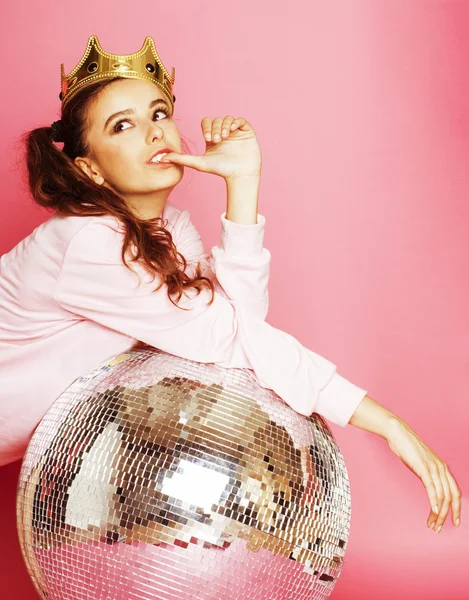 young cute party girl like barbie on pink background with disco ball and crown