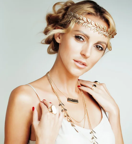 young blond woman dressed like ancient greek godess, gold jewelry close up isolated