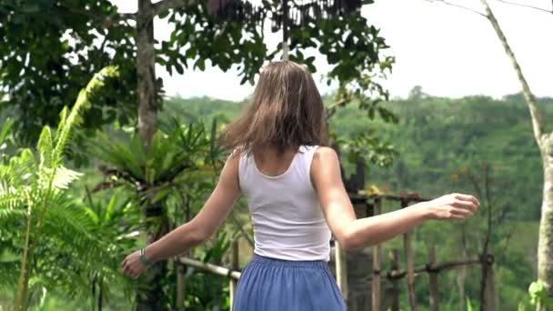 Young, happy woman dancing in garden — Stock Video